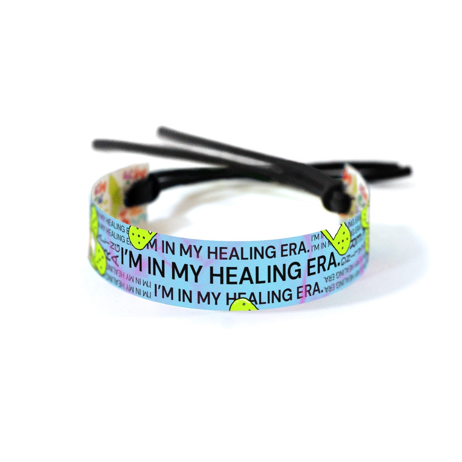 I'm in my Healing Era' repeated in various font sizes against a light blue background, accented with neon green bandage illustrations and subtle pink abstract lines signifying the beautiful chaos of healing.