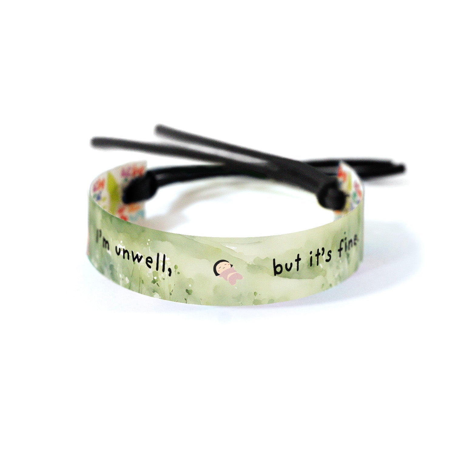 Soft green watercolor background with delicate floral elements, featuring black handwritten text that reads: 'i'm unwell, but it's fine' with a small illustration of a resting child in the middle.